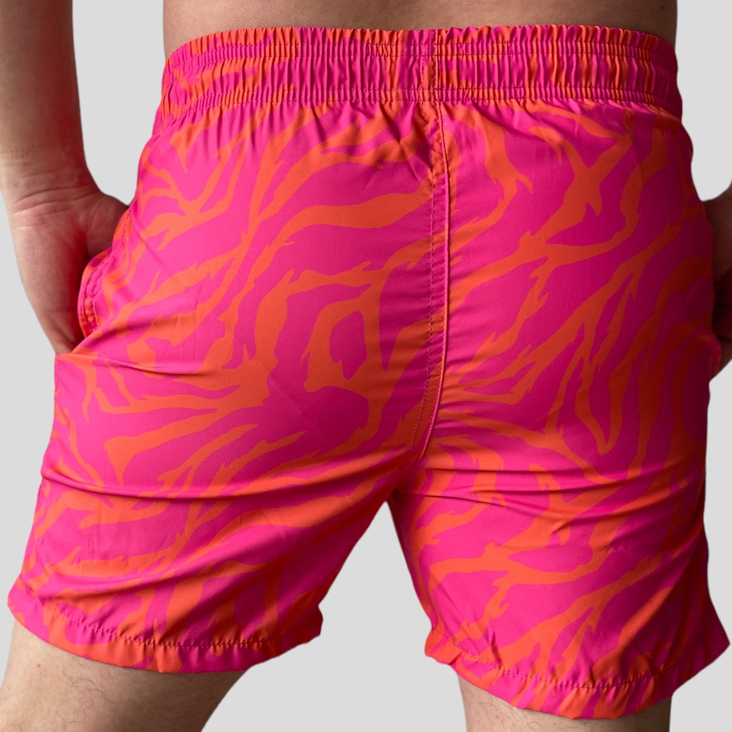 Pantaloneta de baño con diseño animal print naranja y fucsia